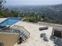 a tiled backyard with an open area and a plunge pool, surrounded by trees, and other buildings