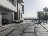 the exterior and landscape of a modern house in los angeles, california with stone and wood