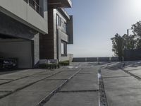 the exterior and landscape of a modern house in los angeles, california with stone and wood