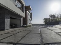 the exterior and landscape of a modern house in los angeles, california with stone and wood