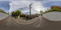 a view looking up at a street through a fish eye lens camera while parked cars are parked