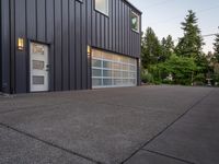 a garage door sitting next to a building with two windows and a bike rack in the front