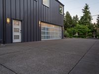 a garage door sitting next to a building with two windows and a bike rack in the front