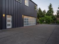 a garage door sitting next to a building with two windows and a bike rack in the front