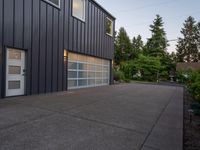 a garage door sitting next to a building with two windows and a bike rack in the front