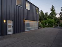 a garage door sitting next to a building with two windows and a bike rack in the front