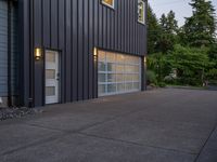 a garage door sitting next to a building with two windows and a bike rack in the front