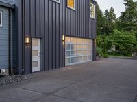 a garage door sitting next to a building with two windows and a bike rack in the front