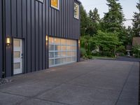 a garage door sitting next to a building with two windows and a bike rack in the front