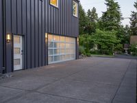 a garage door sitting next to a building with two windows and a bike rack in the front