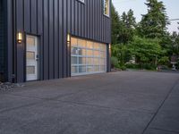 a garage door sitting next to a building with two windows and a bike rack in the front