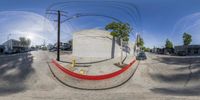 the view of a city street from underneath a convex lens lensed image of power lines