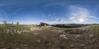 the house has been taken in a fish eye lens for its size and shape to look like it's sitting in a field