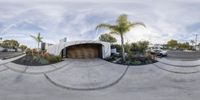 a fish eye view of a skateboard ramp and palm trees with the front doors open