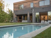 the pool in this modern home features an above ground pool and a nice landscaping with lots of privacy