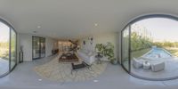 this is a panoramic view of a living room and dining area with an outdoor pool in the back