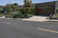 an empty residential street, with the houses next to it and no one on the street