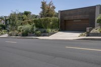 an empty residential street, with the houses next to it and no one on the street