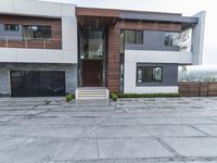 the exterior and landscape of a modern house in los angeles, california with stone and wood