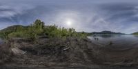 a 360 - shot picture showing the view of a river, and an island in the background