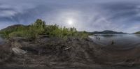 a 360 - shot picture showing the view of a river, and an island in the background