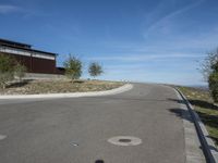 an empty street and parking lot, on a clear day in the desert, with no cars