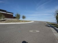 an empty street and parking lot, on a clear day in the desert, with no cars