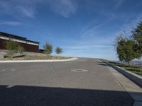 an empty street and parking lot, on a clear day in the desert, with no cars