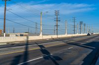 California Road: Bridge Overhead on Asphalt, with Clouds in the Sky