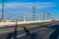 California Road: Bridge Overhead on Asphalt, with Clouds in the Sky