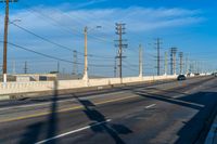 California Road: Bridge Overhead on Asphalt, with Clouds in the Sky