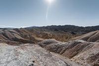 a very scenic photo of a large, badlands like area with huge rocks on it