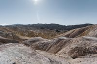 a very scenic photo of a large, badlands like area with huge rocks on it