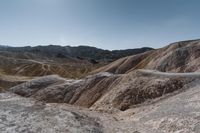 a very scenic photo of a large, badlands like area with huge rocks on it