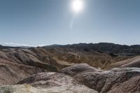 a very scenic photo of a large, badlands like area with huge rocks on it