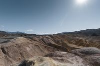 a very scenic photo of a large, badlands like area with huge rocks on it