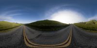 two road with hills and blue sky in the background with a lens in motion to make them look larger