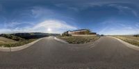 a fish - eye lens photo of the side of a road with a stop sign