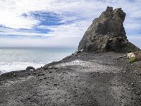 the rocky beach is empty and empty, so it looks like the ocean is crashing