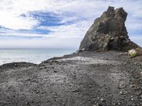 the rocky beach is empty and empty, so it looks like the ocean is crashing