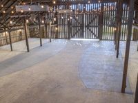 the inside of a barn with lights hanging from the ceiling and many wooden beams, which hold more than two floors