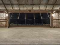 a barn filled with lots of lights in a room of wood flooring and metal ceiling