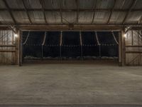 a barn filled with lots of lights in a room of wood flooring and metal ceiling