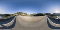 the sky is blue as the road bends around an intersection where it is being turned toward