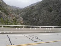 a road with markings painted on it and a yellow line on the side of the road