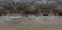 an empty skate park in the middle of a big dome with high ceilings and flooring