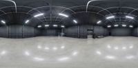 a skate park has concrete floors and light fixtures overhead the floor is shiny gray and white