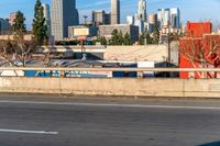 the back of a car drives down the highway in front of a large city skyline