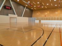 a sports gymnasium with a wooden floor and white walls with a goalie ball in the middle of the court