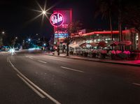 this is a picture of an american food store in california city by night on a city street